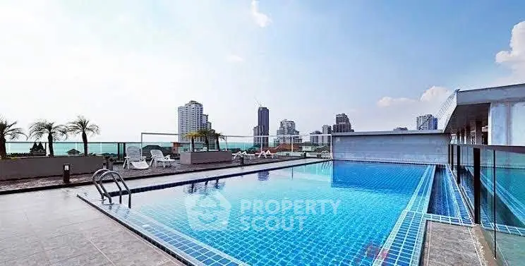 Stunning rooftop pool with city skyline views, perfect for relaxation and leisure.