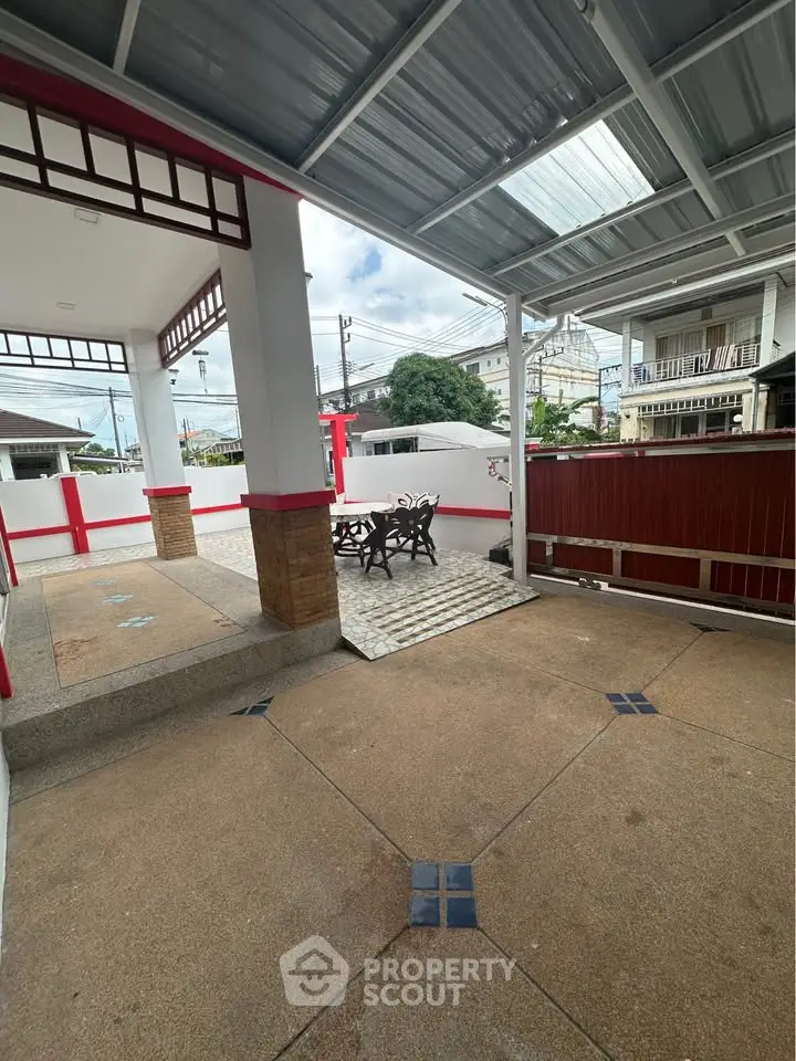 Spacious covered patio with seating area in a modern residential property.