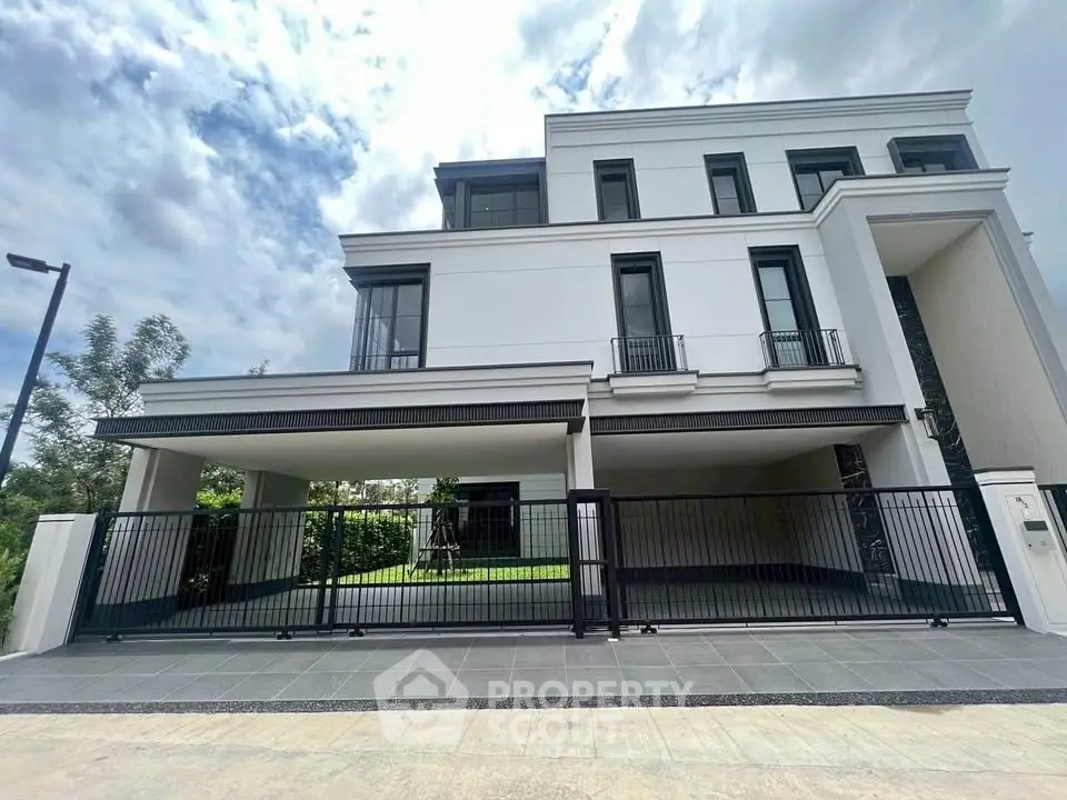 Luxurious modern white villa with spacious driveway and lush greenery, perfect for upscale living.