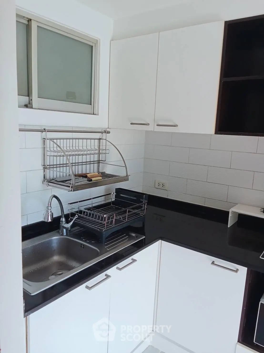 Modern kitchen with sleek black countertops and white cabinetry