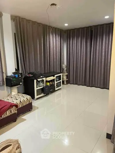 Spacious living room with modern decor and large windows for natural light.