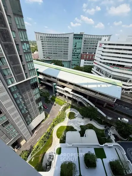 Stunning aerial view of modern urban architecture with lush green landscaping and city skyline.