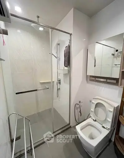 Modern bathroom with glass shower enclosure and sleek fixtures