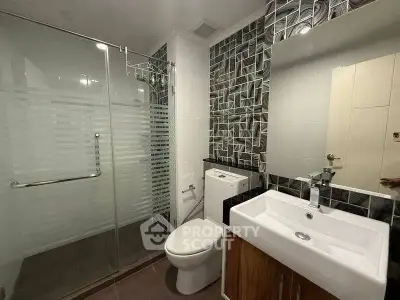 Modern bathroom with glass shower and stylish tile design
