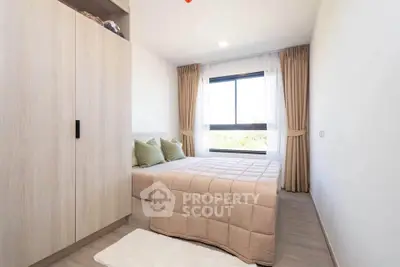 Bright and cozy bedroom with large window and modern decor