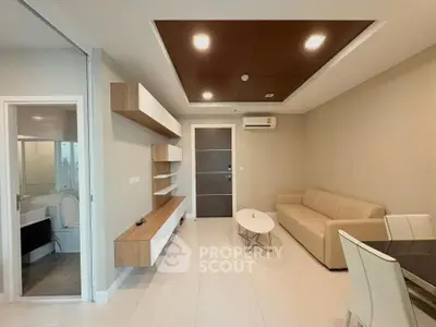 Modern living room with beige sofa, sleek shelving, and elegant dining area in open layout.