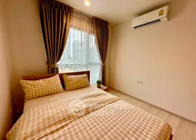 Cozy bedroom with city view, featuring modern air conditioning and stylish decor.