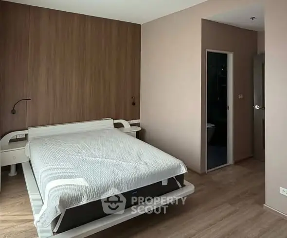 Modern bedroom with wooden accent wall and sleek design