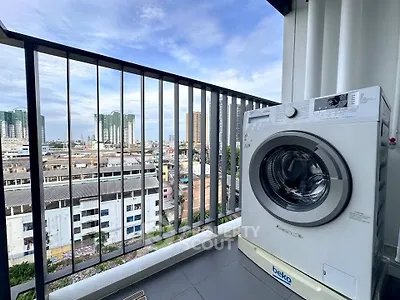 Modern balcony with city view and washing machine, perfect for urban living.
