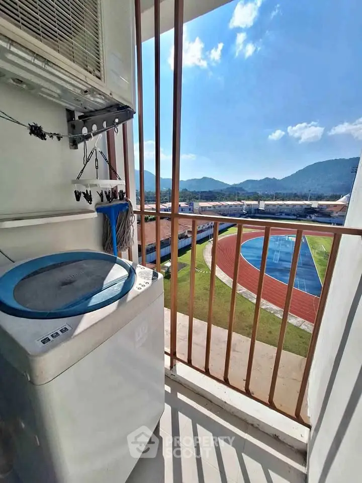 Charming balcony with washing machine and scenic mountain view