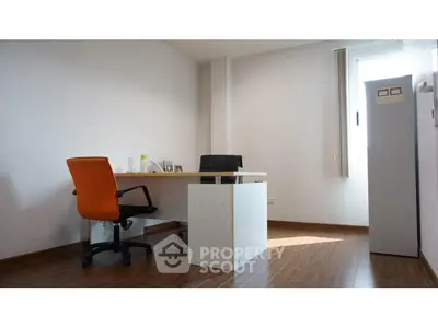 Modern study room with wooden flooring and natural light