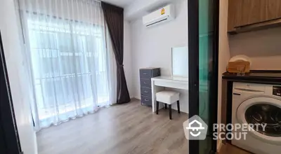 Modern apartment interior with washing machine and vanity, featuring large window and elegant curtains.