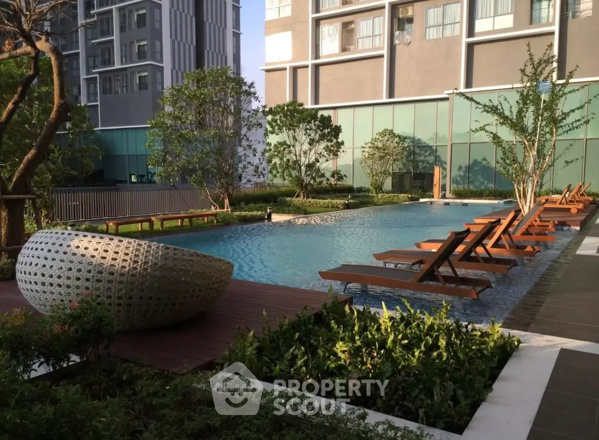 Luxurious apartment complex with serene poolside and modern architecture.