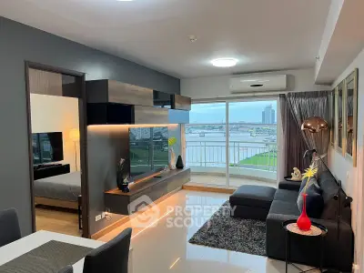 Modern living room with stunning river view and stylish decor in high-rise apartment.