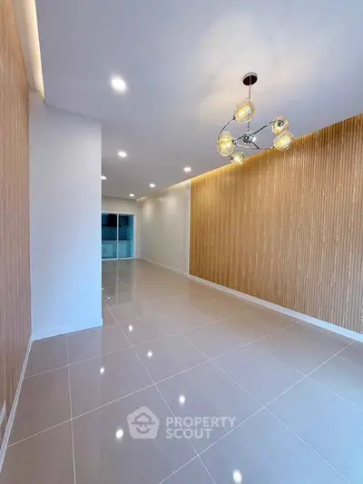 Spacious modern living room with elegant lighting and stylish wall design