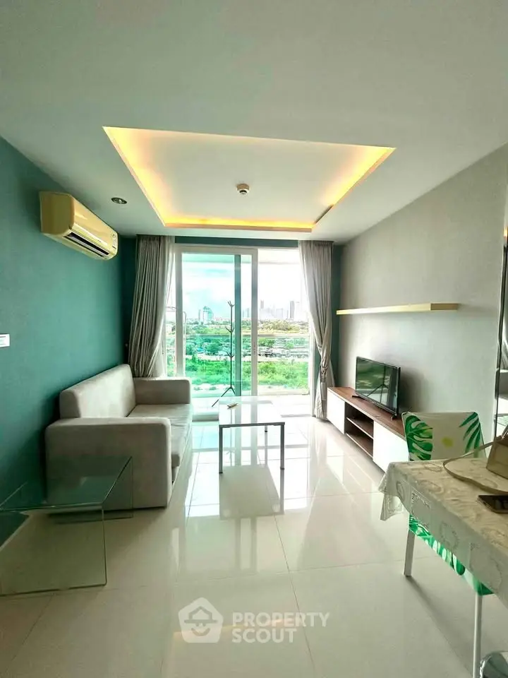 Modern living room with city view, featuring sleek furniture and large windows for natural light.