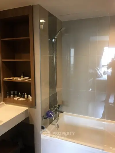 Modern bathroom with sleek bathtub and built-in shelving