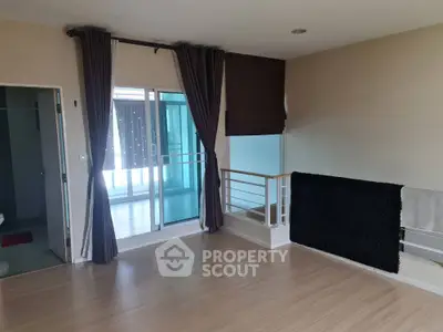 Spacious interior with wooden flooring and balcony access