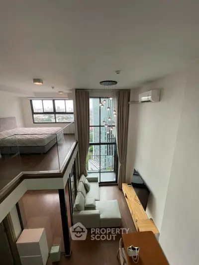 Modern loft apartment with high ceilings and large windows offering stunning city views.