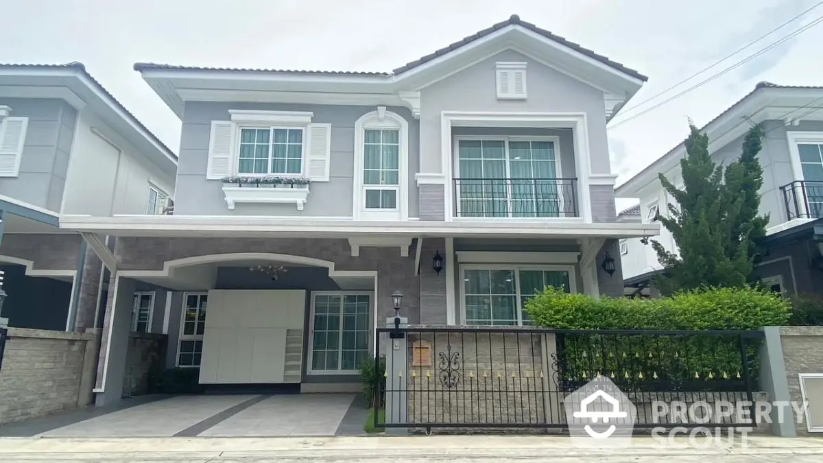 Elegant two-story house with modern facade and lush greenery in a serene neighborhood.