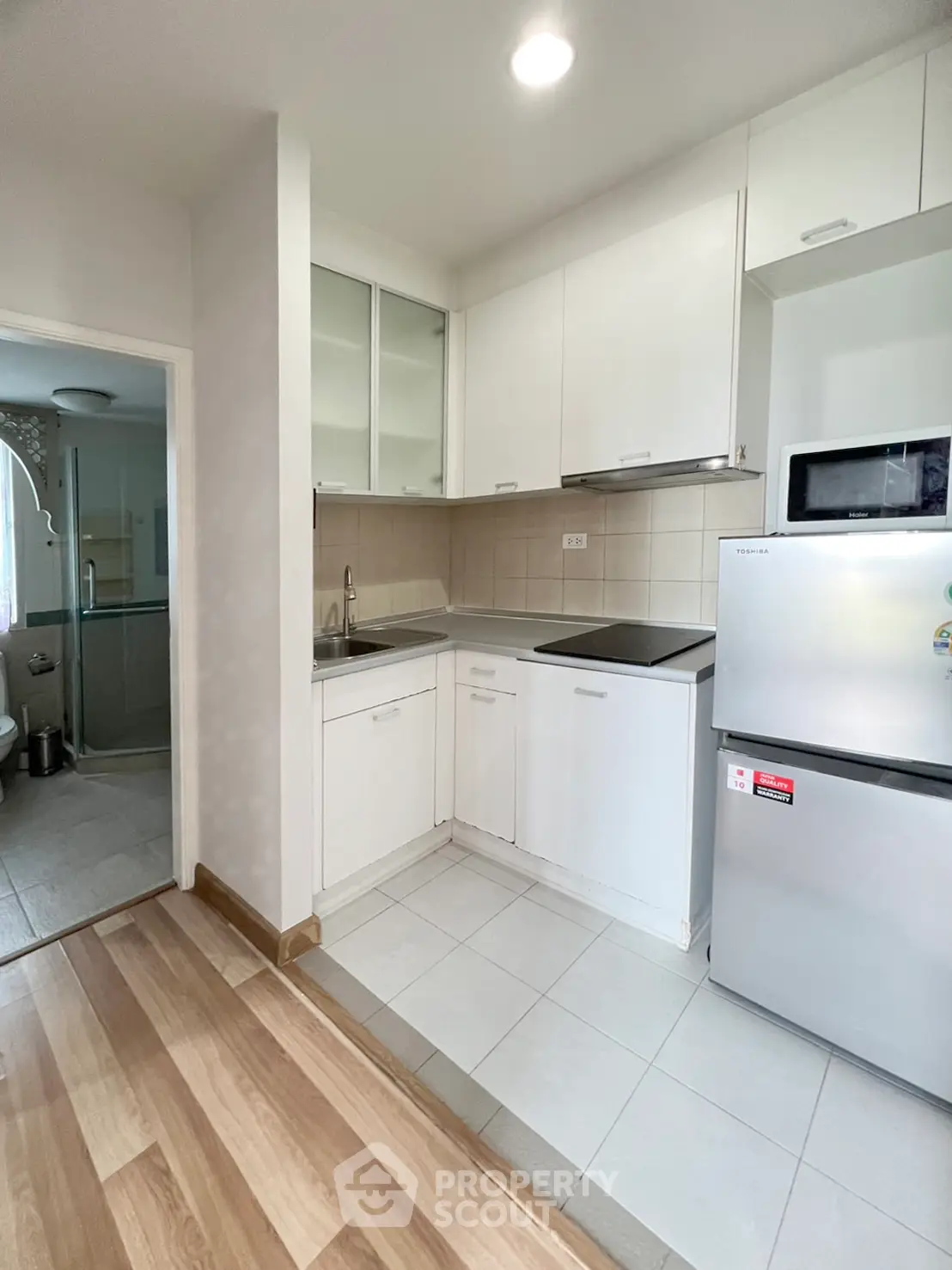 Modern kitchen with sleek white cabinets and stainless steel appliances