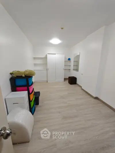 Spacious storage room with shelves and colorful bins, ideal for organized living.