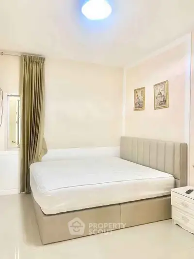 Spacious bedroom with elegant decor and natural light
