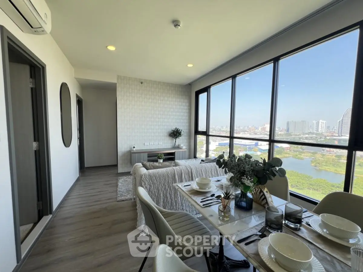 Modern living room with panoramic city view and stylish dining area