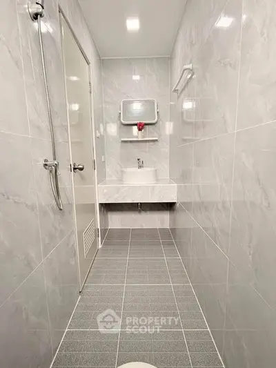 Modern bathroom with sleek gray tiles and minimalist fixtures