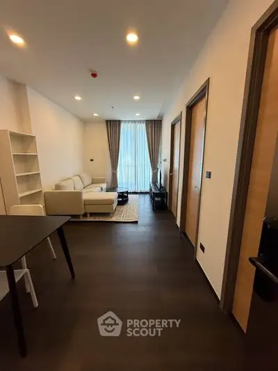 Modern living room with sleek furniture and large window in a stylish apartment.