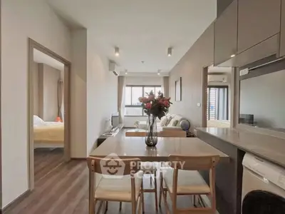 Modern open-plan living and dining area with stylish decor and natural light.