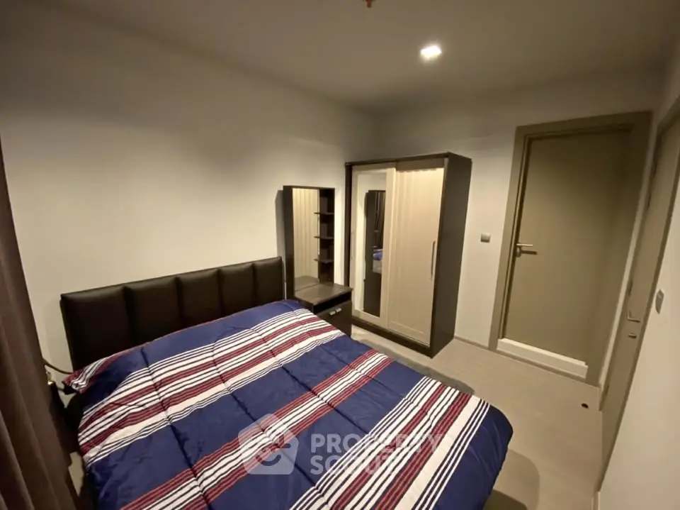 Cozy bedroom with modern furniture and stylish bedding in a contemporary apartment.