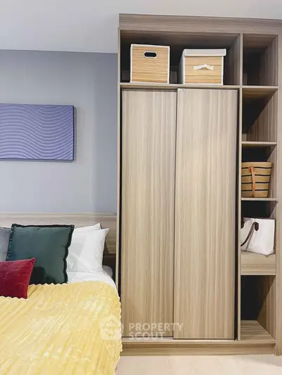 Modern bedroom with stylish wooden wardrobe and cozy bedding