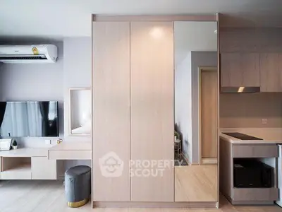 Modern living room with sleek furniture and built-in storage in a stylish apartment.