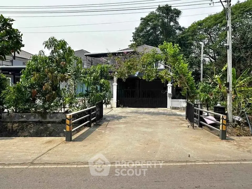 Charming suburban home with lush greenery and private driveway, perfect for serene living.