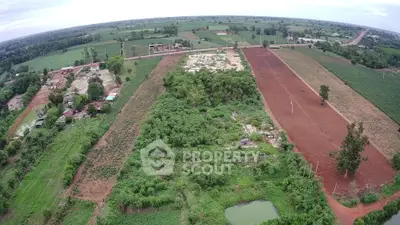 Expansive aerial view of lush farmland with diverse crops and open fields, ideal for agricultural investment.