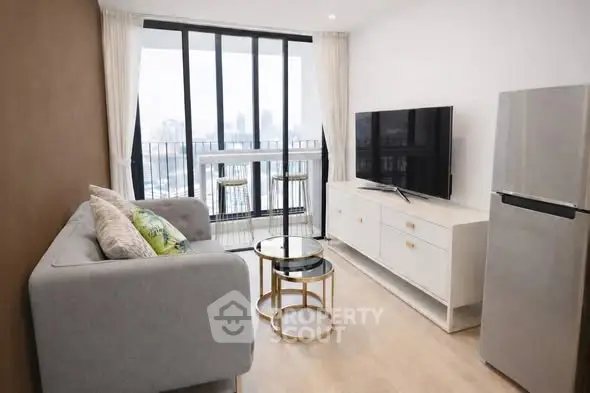 Modern living room with city view, stylish furniture, and large windows for natural light.
