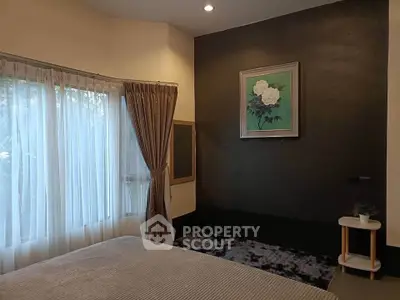 Elegant bedroom with large window and stylish decor