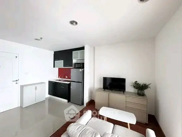 Modern living room with sleek kitchen, stylish furniture, and contemporary decor.