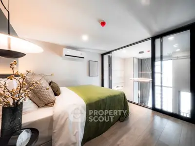 Modern bedroom with large windows and stylish decor in a high-rise apartment.