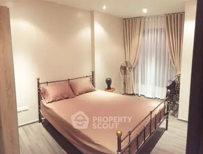 Cozy bedroom with elegant decor and natural light, featuring a stylish bed and modern furnishings.