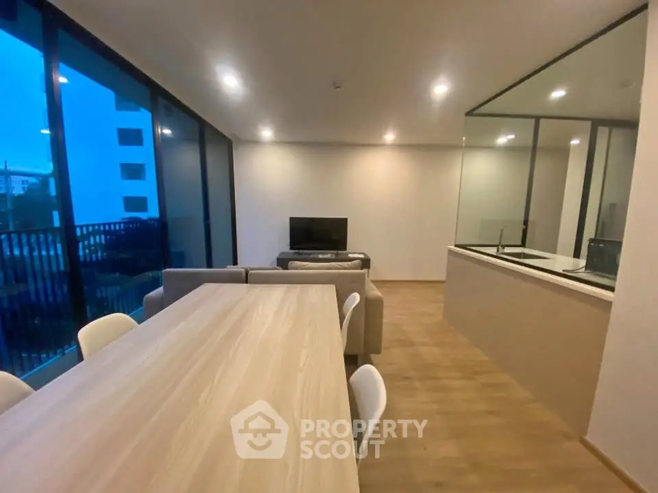 Modern open-plan living room with dining area and sleek kitchen design