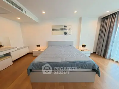 Spacious modern bedroom with large bed and natural light