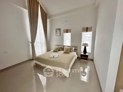 Spacious modern bedroom with high ceilings and elegant decor
