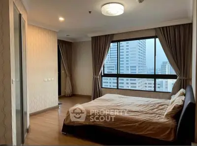 Spacious bedroom with city view in modern apartment