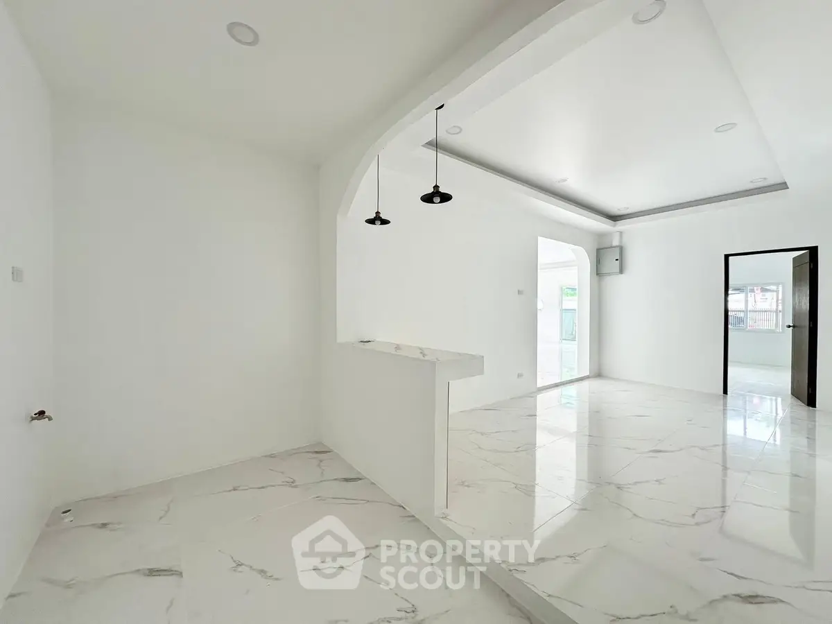 Spacious modern interior with sleek marble flooring and open layout design.