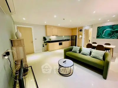 Modern open-plan living room with sleek kitchen and stylish decor