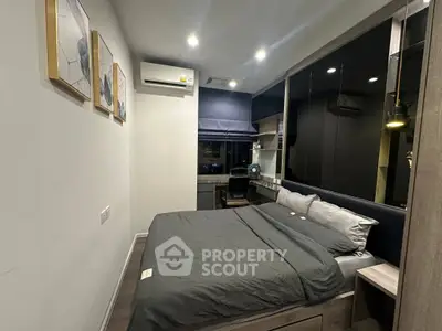 Modern bedroom with sleek design and cozy ambiance, featuring stylish decor and ample lighting.