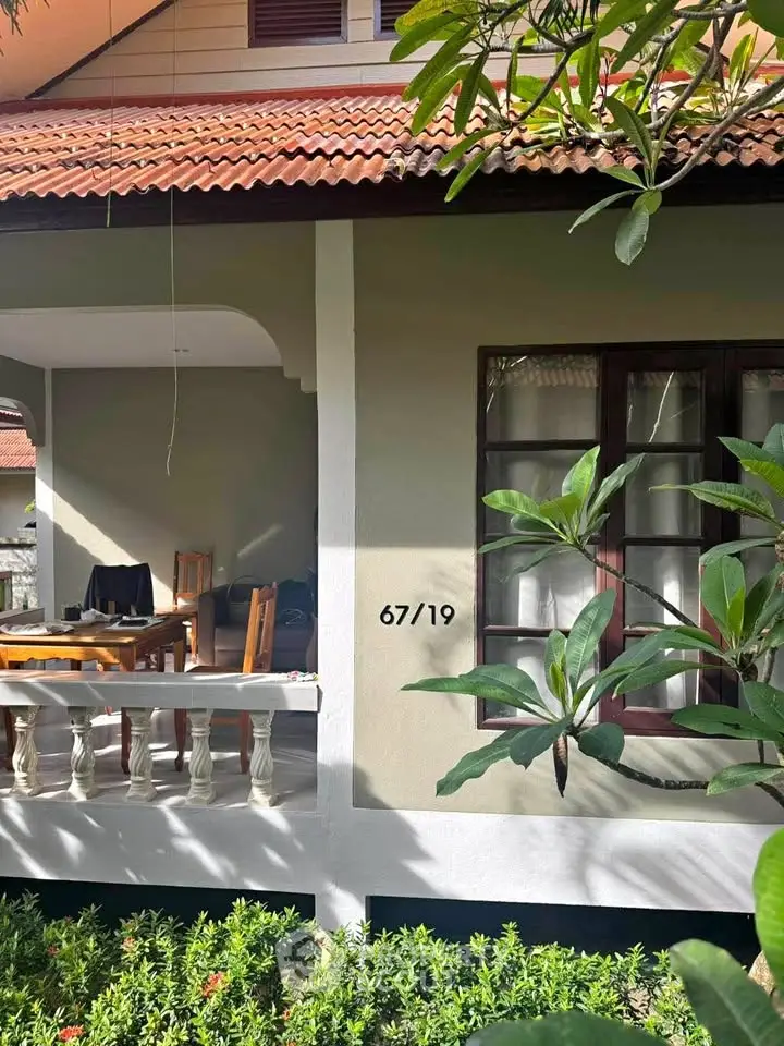 Charming residential property with inviting porch and lush greenery, perfect for serene living.