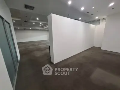 Spacious commercial interior with modern lighting and open layout, ideal for versatile business setups.